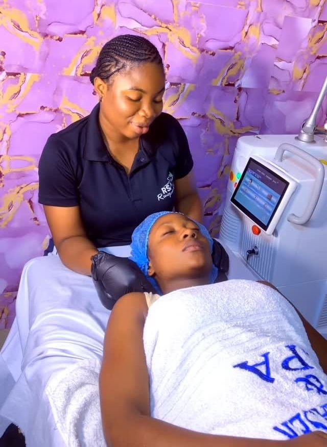 A therapist with a client in the laser treatment room